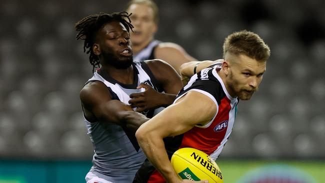 Martin Frederick lays a tackle on St Kilda forward Dan Butler.