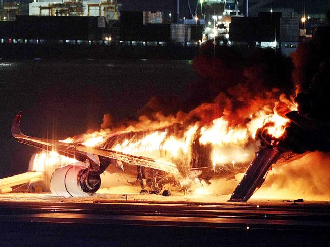 TOPSHOT - This photo provided by Jiji Press shows a Japan Airlines plane on fire on a runway of Tokyo's Haneda Airport on January 2, 2024. A Japan Airlines plane was in flames on the runway of Tokyo's Haneda Airport on January 2 after apparently colliding with a coast guard aircraft, television reports said. (Photo by JIJI PRESS / AFP) / Japan OUT