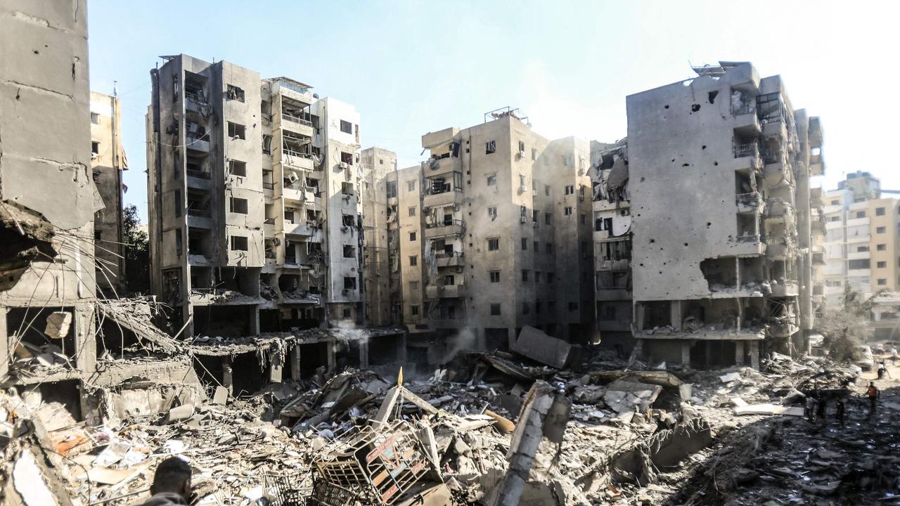 People check the rubble of buildings which were levelled on September 27 by Israeli strikes that targeted and killed Hezbollah leader Hassan Nasrallah in the Haret Hreik neighbourhood of Beirut's southern suburbs, on September 29, 2024. Picture: AFP