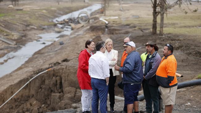 Labor MP Jason Clare, Federal Member for Macquarie Susan Templeman and Senator Katie Gallagher, speaking with cattle farmer Emanuel Degabriele and other farmers, as they visit a turf farm in Cornwallice outside Richmond today which was affected by floods. Picture: Tim Hunter.