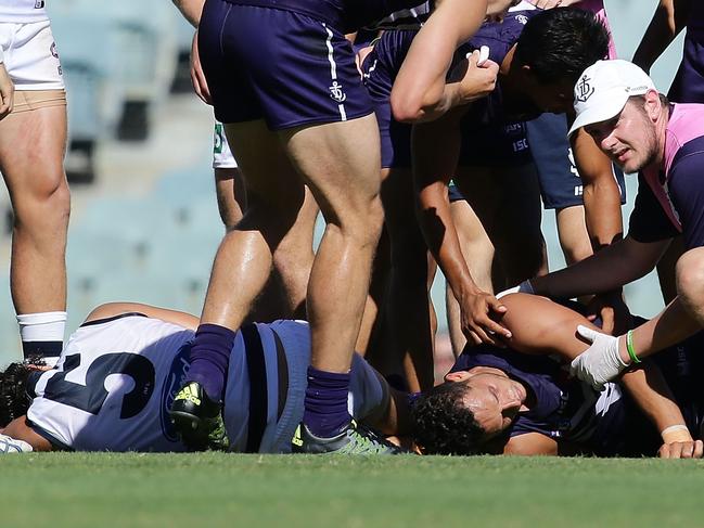 PERTH, AUSTRALIA - MARCH 12: Michael Johnson of the Dockers is assesed by a medic after being spear tackled by Nakia Cockatoo of the Cats during the 2016 NAB Challenge match between the Fremantle Dockers and the Geelong Cats at Domain Stadium, Perth on March 12, 2016. (Photo by Will Russell/AFL Media/Getty Images)