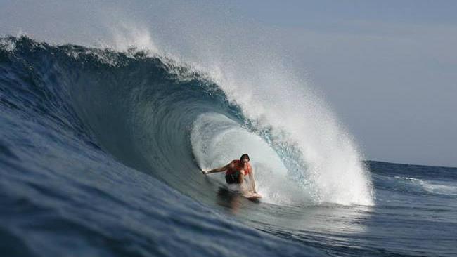 Nathan Teece surfing.