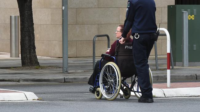 The court sheriff pushes Mark Freer’s wife Kerry to her car. Picture: NCA NewsWire / Tricia Watkinson