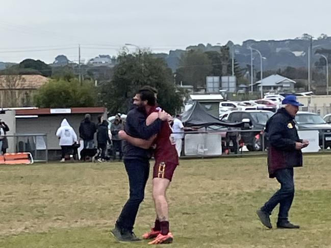 Tyabb coach Anthony Agius is embraced by Corey Buchan after the final siren.