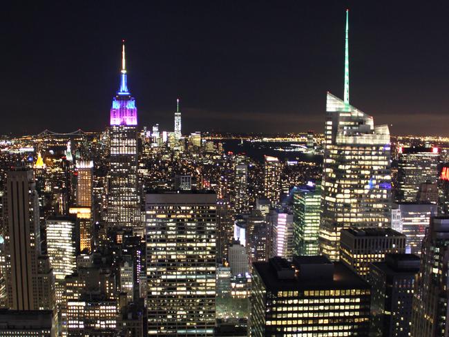 ESCAPE: NEW YORK .. Simon Tsang story .. View of Empire State Building and One World Trade Center at night from Top of the Rock. Picture: Simon Tsang