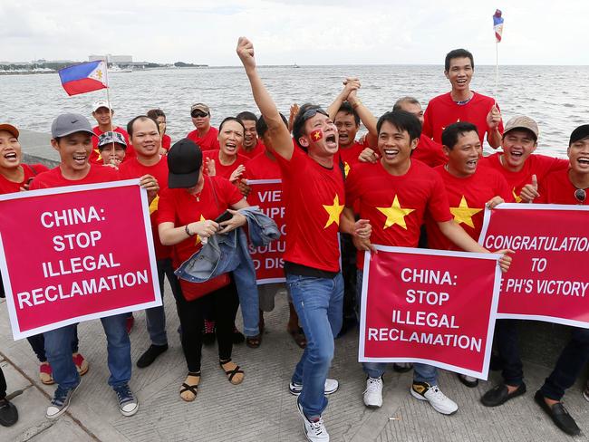 Vietnamese expatriates cheer while displaying placards during a rally by the Manila's baywalk. Picture: AP