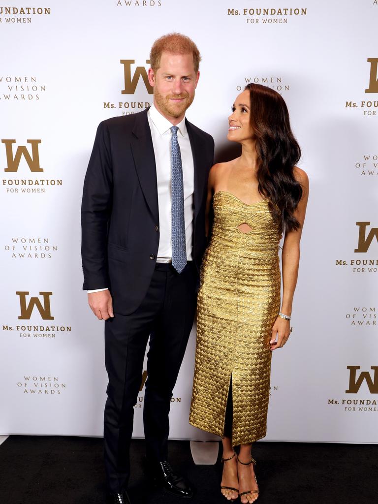 Prince Harry and Meghan Markle posing for photos Picture: Getty Images