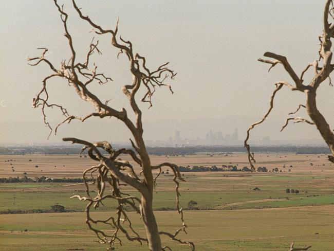 03/08/2000. Earth Sanctuaries in the You Yangs. Farm, grazing paddock view with Melbourne skyline in the distance.