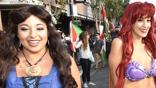 Costumed Comic-Con fans get out of the way as pro-Palestinian demonstrators march in the Gaslamp Quarter outside of the San Diego Convention Center on day two of the 2014 Comic-Con International Convention held Friday, July 25, 2014, in San Diego. (Photo by Denis Poroy/Invision/AP)