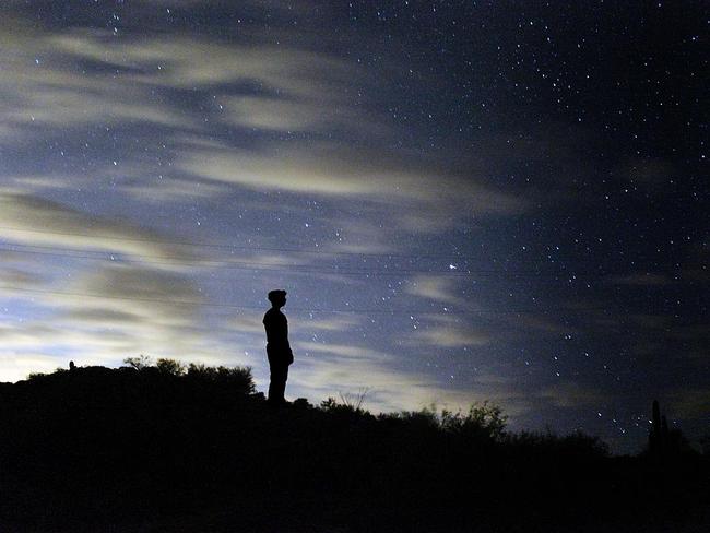 What the City Does Not Show You ... A man stands on a hill on Canyon Lake, Arizona, silhouetted against a night sky that fades from the moody, blue light pollution seen on the right hand side to the darkness that hangs over the desert. Picture: Jasmeen Villalobos, Insight Astronomy Photographer of the Year 2016 Young Winner