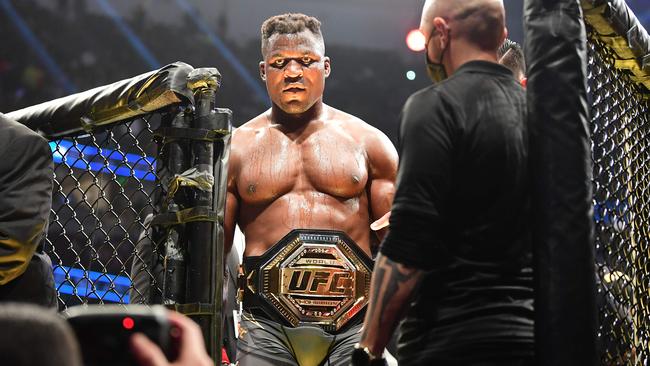 UFC 270 heavyweight world champion Cameroon's Francis Ngannou (C) celebrates victory over France's Ciryl Gane. (Photo by Frederic J. BROWN / AFP)