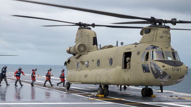 Royal Australian Navy sailors from HMAS Adelaide's flight deck team prepare an Australian Arm CH-47F Chinook helicopter for take off during Operation Tonga Assist 2022. The Australian Defence Force is supporting the Department of Foreign Affairs and Trade (DFAT)-led effort to support the Government of Tonga following the eruption of underwater volcano Hunga Tonga- Hunga Ha’apai on January 15. Picture: CPL Robert Whitmore