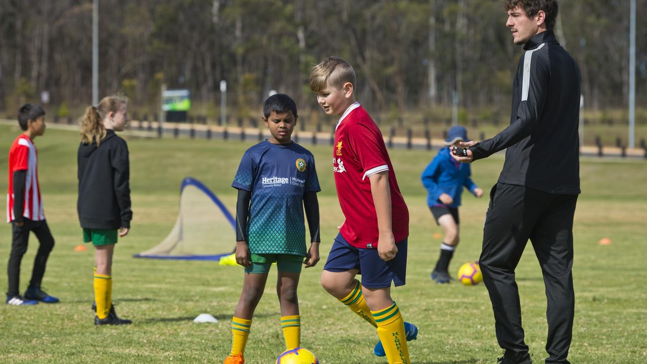 Viren Sevakumar (left) and Tom Pezet under instruction from coach Mirko Crociati during the Brisbane Roar Academy Highfields FC July holiday camp, Sunday, July 5, 2020. Picture: Kevin Farmer