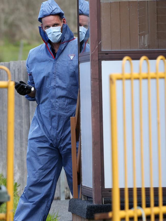 A investigating officer at the West Ulverstone property earlier today.