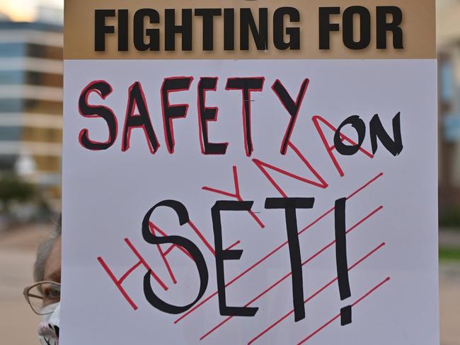 A film worker holds a sign during a vigil for Halyna Hutchins. Picture: Getty Images