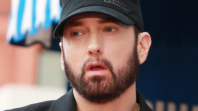 (FILES) In this file photo taken on January 30, 2020 Eminem speaks during a ceremony honoring 50 Cent with a star on the Hollywood Walk of Fame in Hollywood, California. - Music's A-listers will celebrate a new crop of legends entering the Rock and Roll Hall of Fame this weekend, among them country queen Dolly Parton and rap agitator Eminem. (Photo by Leon Bennett / GETTY IMAGES NORTH AMERICA / AFP)