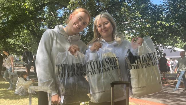 Swifties Ella Passchier, 18 and Jorja Elson, 19, with their merchandise after they flew all the way from Perth.