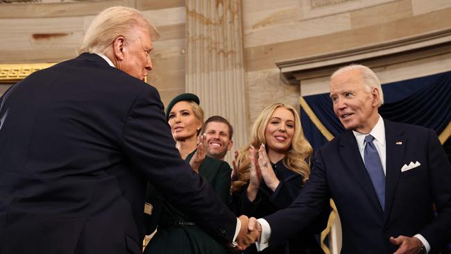 US President Donald Trump and former US President Joe Biden shake hands during inauguration ceremonies in the Rotunda of the US Capitol.