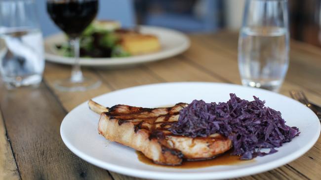 The chargrilled pork cutlet, braised red cabbage, apple puree and jus at Driftwood in Lauderdale. Picture: LUKE BOWDEN