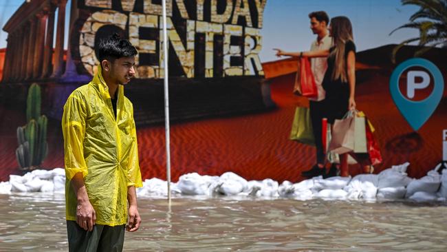 A man stands in a flooded street in Sharjah on April 17, 2024. Picture: Ahmed Ramazan / AFP