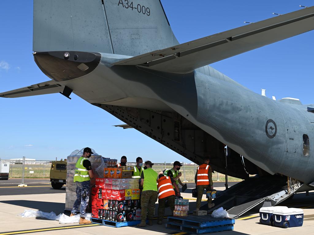 Supplies were loaded onto a Royal Australian Air Force C-27J Spartan at the RAAF Base Edinburgh to fly in essential food to Coober Pedy which has been affected by flooded roads. Picture: NCA NewsWire / Naomi Jellicoe