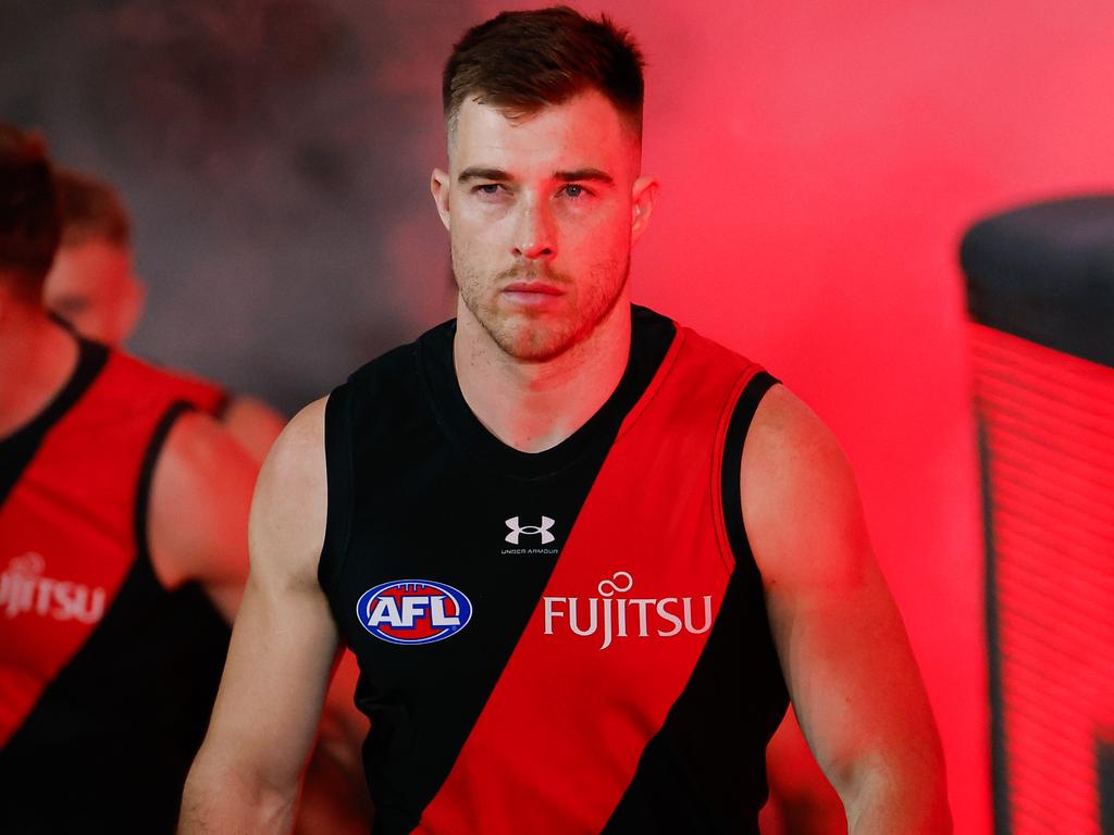 MELBOURNE, AUSTRALIA - AUG 16: Zach Merrett of the Bombers leads his team up the race during the 2024 AFL Round 23 match between Essendon Bombers and the Sydney Swans at Marvel Stadium on August 16, 2024 in Melbourne, Australia. (Photo by Dylan Burns/AFL Photos via Getty Images)