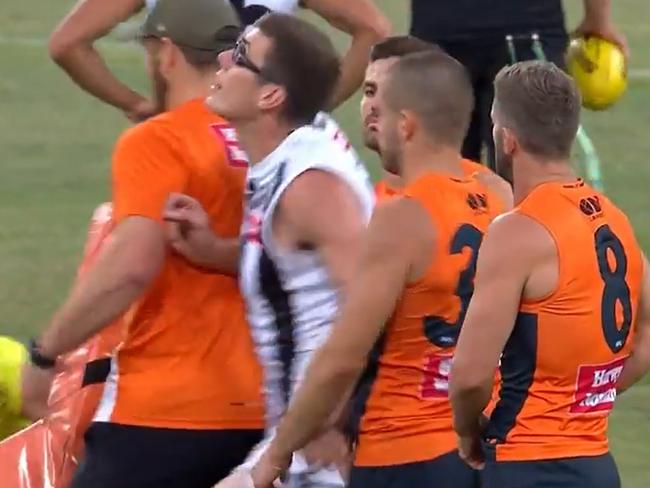 Pies ruckman Mason Cox - public enemy No.1 at GWS - runs through the Giants ruck warm-up and takes the ball