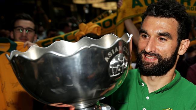 Socceroos captain Mile Jedinak poses with the Asian Cup during celebrations in Sydney.
