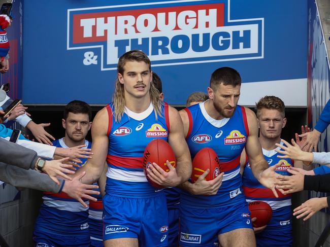 MELBOURNE, AUSTRALIA - July 29, 2023. AFL .        Bailey Smith leads the team out for game 100 during the round 20 match between Western Bulldogs and GWS Giants at the Mars Stadiumon July 29, 2023, in Ballarat, Australia. Photo by Michael Klein.