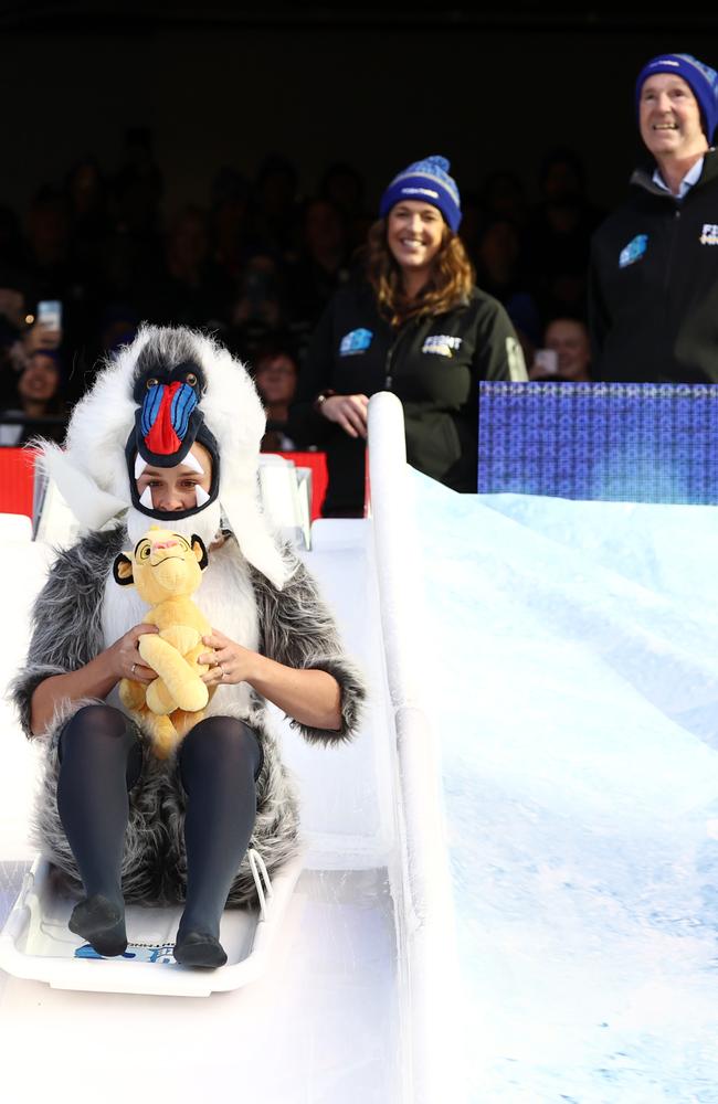 Neale and Bec Daniher look on as Ash Barty takes the slide. Picture: Michael Klein