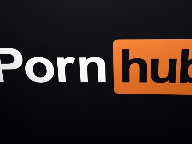 (FILES) In this file photo taken on January 23, 2018, a Pornhub logo is displayed at the company's booth at the 2018 AVN Adult Entertainment Expo at the Hard Rock Hotel & Casino in Las Vegas, Nevada. - Adult content giant Pornhub has announced the "suspension" of content uploaded by non-verified users as the site faces turmoil over claims of turning a blind eye to videos of child abuse, rape and revenge porn. Pressure has mounted since the New York Times published a piece accusing the site of profiting from abusive content, with Visa and Mastercard announcing they would no longer process payments to Pornhub. (Photo by Ethan Miller / GETTY IMAGES NORTH AMERICA / AFP)