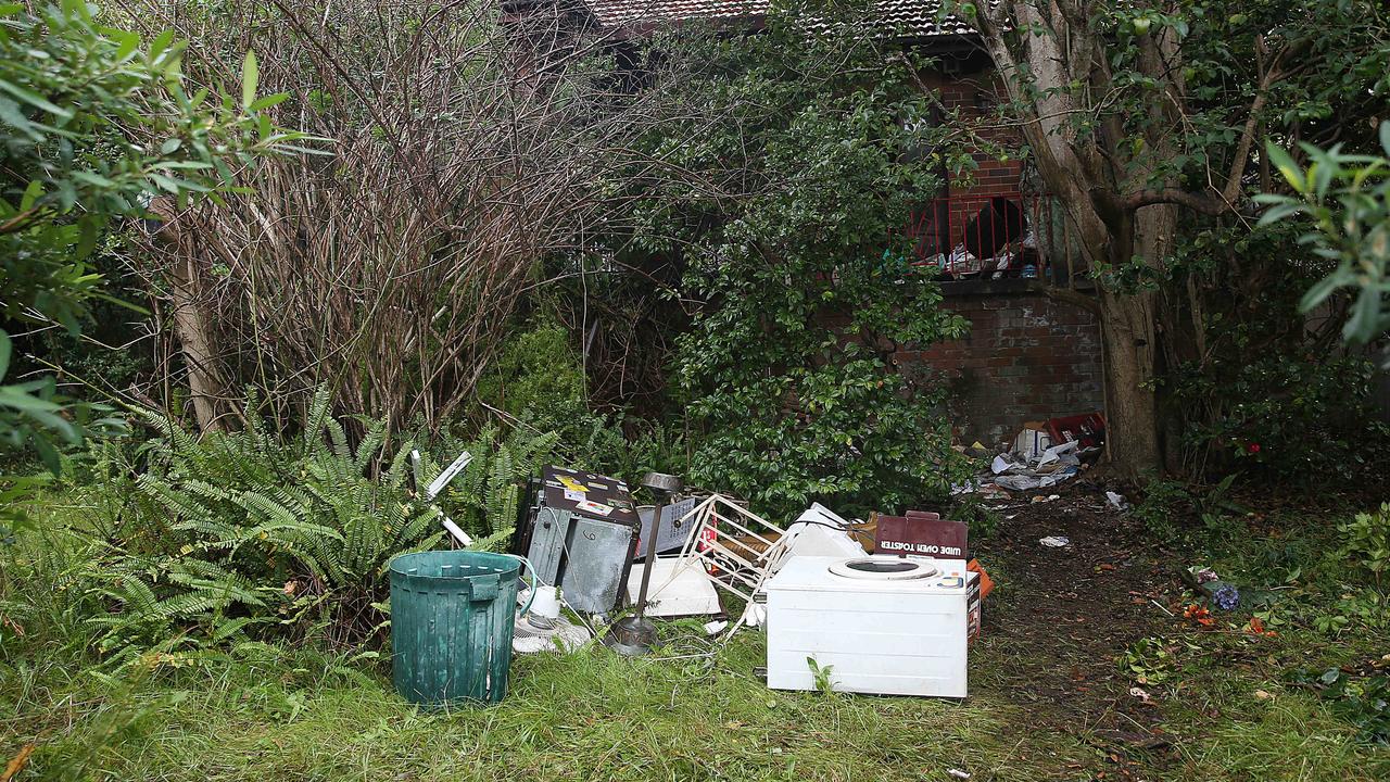 Junk in the garden of hoarder Bruce Roberts’ Greenwich home was cleared and cleaners found the decomposed body of Shane Snellman inside.