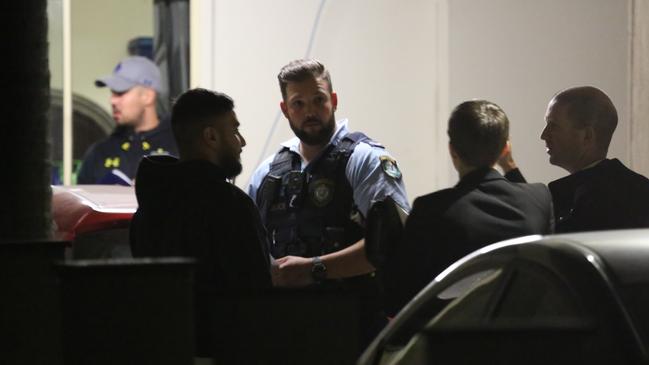 Police speak to the family of the 25-year-old victim at the scene. Picture: Damian Hofman