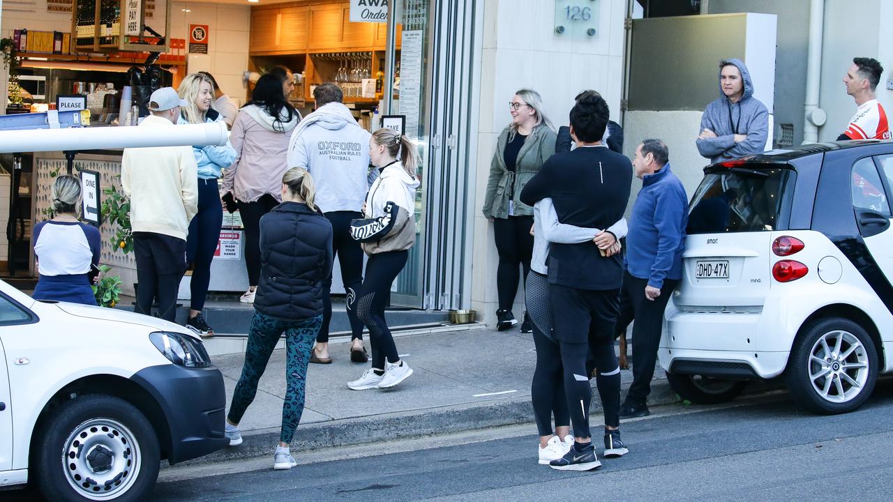 People crowd outside a Bondi cafe.