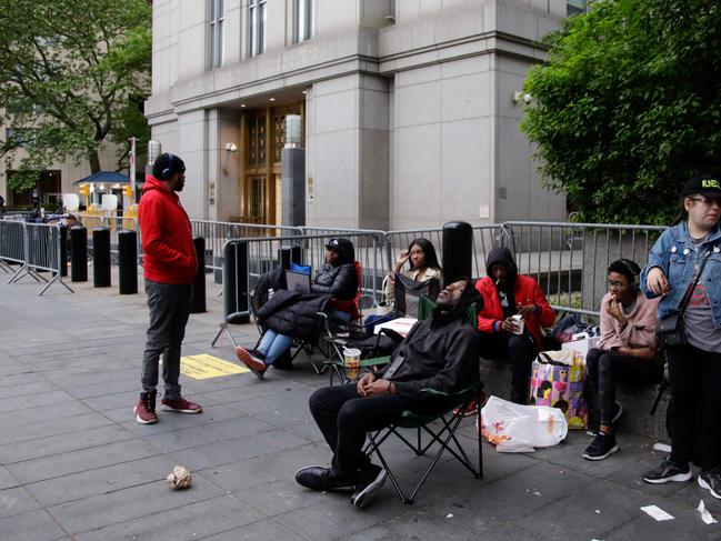 People wait in line outside federal court. Picture: AFP