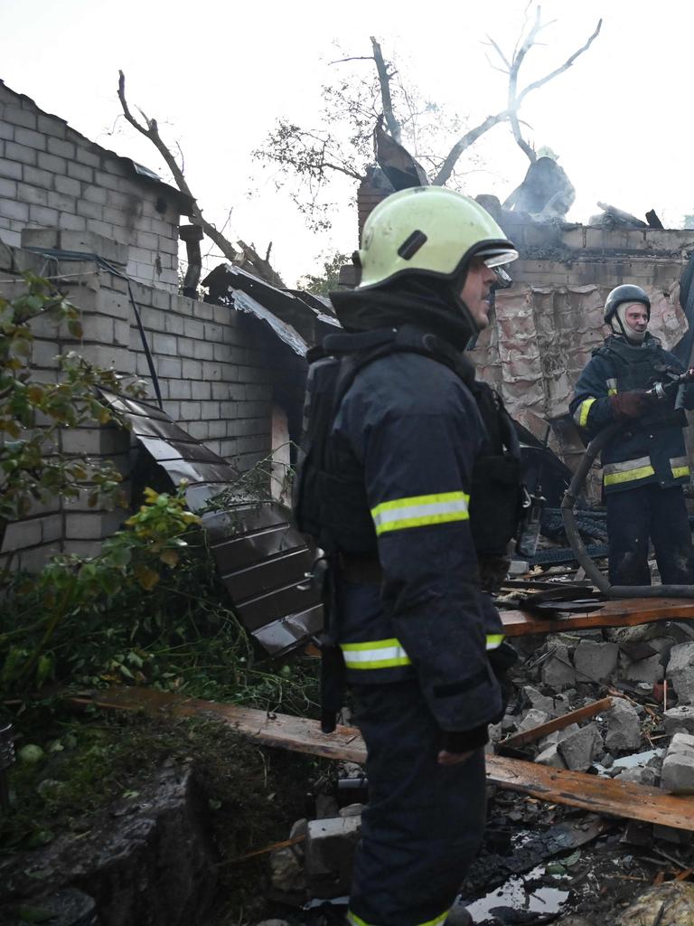 Ukrainian firefighters work to extinguish a fire in a residential building at the site of a missile strike in Kharkiv. Picture: SERGEY BOBOK / AFP