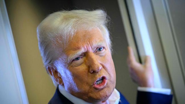 US President Donald Trump speaks with the press on board Air Force One after departing Las Vegas, Nevada, en route to Miami, Florida on January 25, 2025. After visits to disaster sites in North Carolina and California, the Vegas stop is more of a feel-good victory lap, as he lays out his plans to exclude tips from federal taxes -- an enormously popular move in a city built on the hospitality industry. (Photo by Mandel NGAN / AFP)