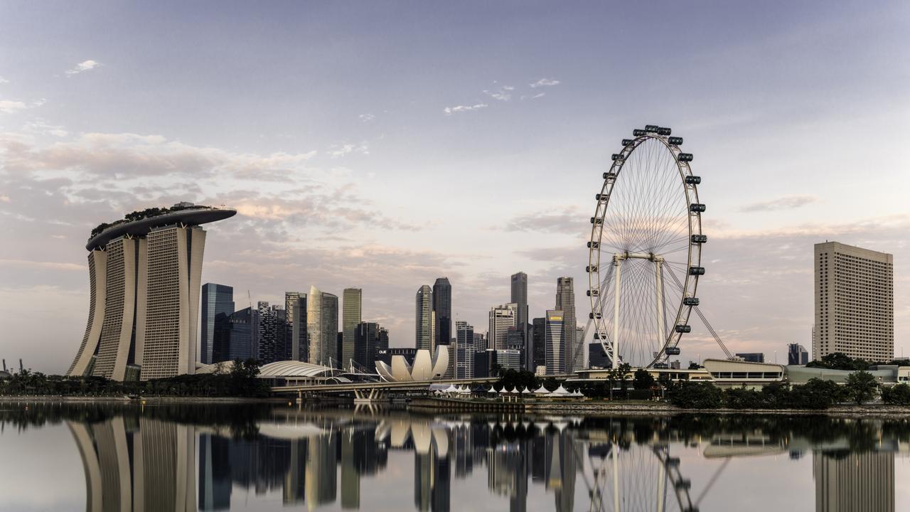 Singapore skyline at dawn, showing the Marina Bay Sands and the Flyer.