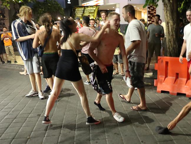 A group punches and kicks each other in the heart of Kuta during schoolies. Picture: Liam Kidston