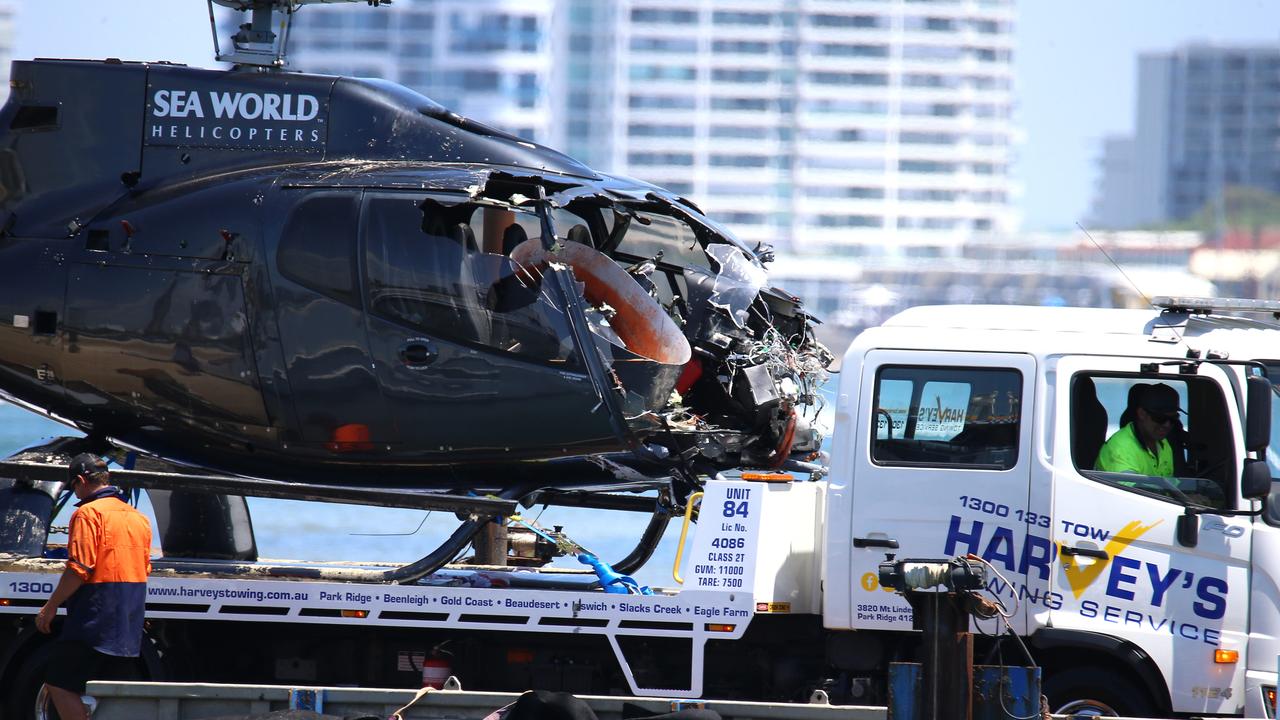 A Sea World helicopter is removed from the scene after the horrific crash that claimed four lives. Picture: NewsWire / David Clark