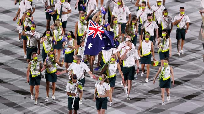 TOKYO, JAPAN – JULY 23: Flag bearers Cate Campbell and Patty Mills of Team Australia lead their team in during the Opening Ceremony of the Tokyo 2020 Olympic Games at Olympic Stadium on July 23, 2021 in Tokyo, Japan. (Photo by Clive Brunskill/Getty Images)