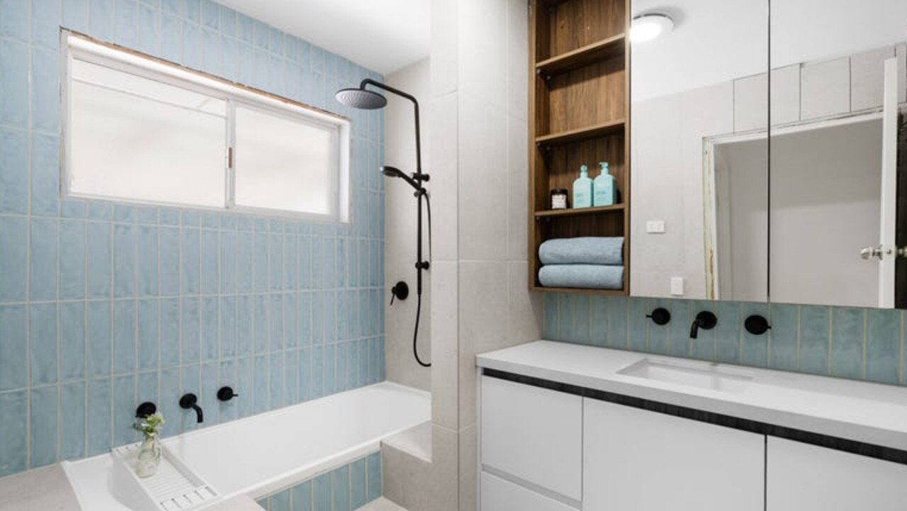 Calming blue colours extend to the stylish renovated bathroom