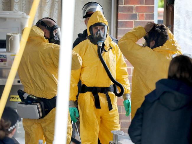 Detectives remove sophisticated drug production equipment from a clandestine drug laboratory, uncovered at Morphett Vale. Picture Dean Martin