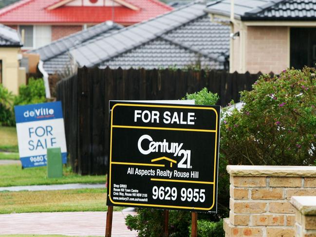 For Sale signs stand at tye front of houses at housing development in Sydney, Australia, on Tuesday, June 3, 2008.  Photographer: Ian Waldie/Bloomberg News