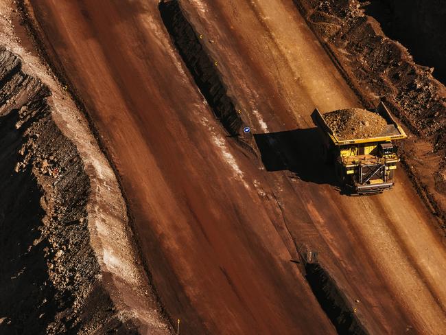 A dumper truck carries excavated iron ore from the iron ore pit at the Sishen open cast mine, operated by Kumba Iron Ore Ltd., an iron ore-producing unit of Anglo American Plc, in Sishen, South Africa, on Tuesday, May 22, 2018. Kumba Iron Ore may diversify into other minerals such as manganese and coal as Africa’s top miner of the raw material seeks opportunities for growth and to shield its business from price swings. Photographer: Waldo Swiegers/Bloomberg