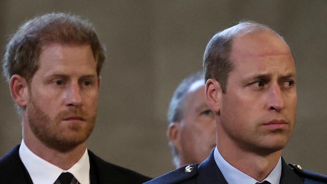 Britain's Prince Harry (L), Duke of Sussex, and Britain's Prince William (R), Prince of Wales, reacts as the coffin of Britain's Queen Elizabeth II arrives at the Palace of Westminster, following a procession from Buckingham Palace, in London on September 14, 2022. - Queen Elizabeth II will lie in state in Westminster Hall inside the Palace of Westminster, from Wednesday until a few hours before her funeral on Monday, with huge queues expected to file past her coffin to pay their respects. (Photo by ALKIS KONSTANTINIDIS / POOL / AFP)