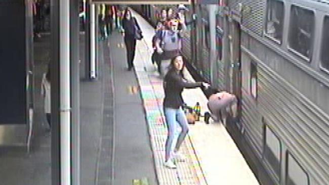 People call for help while the woman tries to retrieve the child. Picture: Sydney Trains