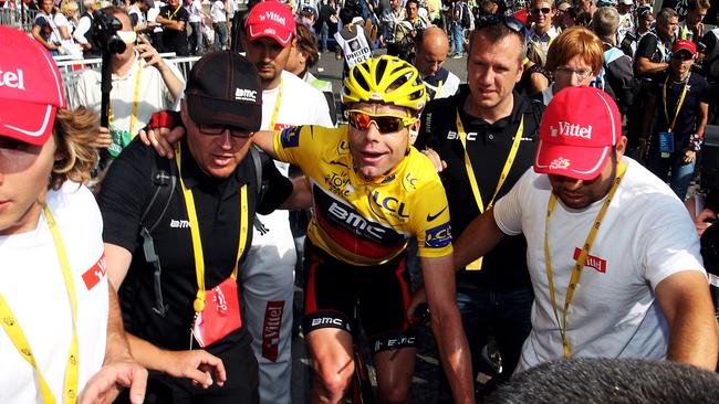 Evans celebrates victory as he is helped across the finish line of the Tour de France. Picture: Michael Steele