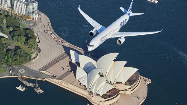 SYDNEY, AUSTRALIA - MAY 02: An Airbus A350-1000 flight test aircraft flies over Sydney Harbour to mark a major fleet announcement by Australian airline Qantas on May 02, 2022 in Sydney, Australia. Twelve Airbus A350-1000's will be ordered to operate non-stop "Project Sunrise" flights from Australia's east coast to New York, London and other key destinations. The aircraft will feature market-leading passenger comfort in each travel class with services to start by the end of 2025. (Photo by James D. Morgan/Getty Images for Airbus/Qantas) *** BESTPIX ***