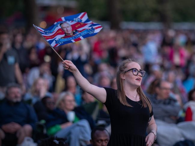 A woman in the crowd waves a Union Jack flag as she watches the concert. Picture: Getty Images